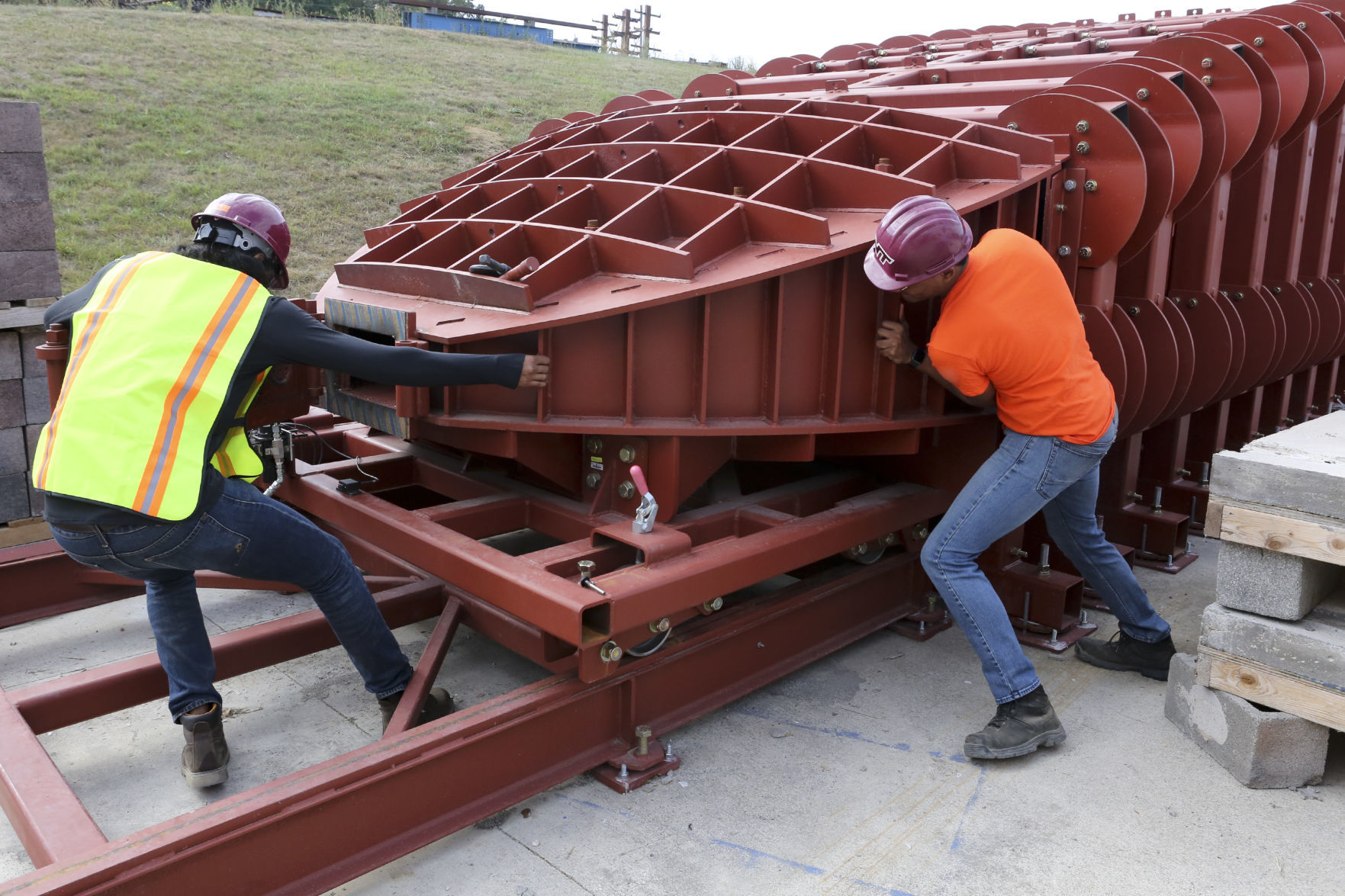 Engineer graduate students open the shock tube between tests.